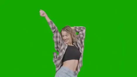 Studio Shot Of Young Woman Having Fun Dancing Against Green Screen 2