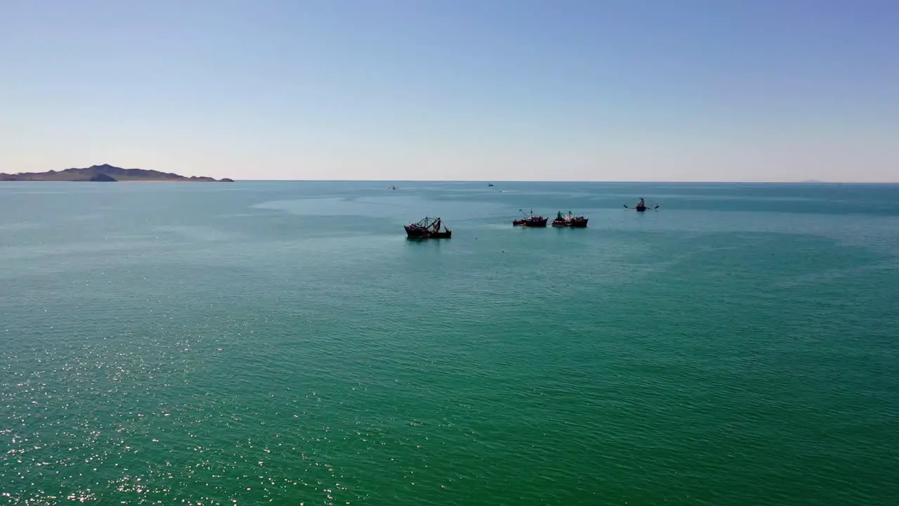 Flight to anchored fishing boat in the bay