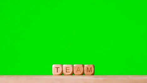 Business Concept Wooden Letter Cubes Or Dice Spelling Team Against Green Screen