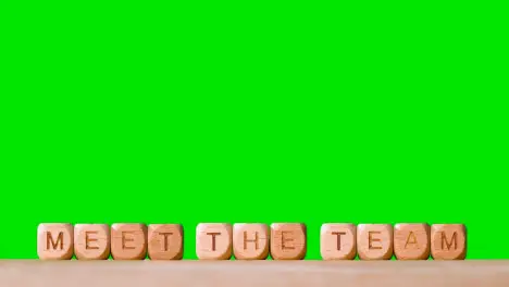 Business Concept Wooden Letter Cubes Or Dice Spelling Meet The Team Against Green Screen