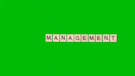 Stop Motion Business Concept Overhead Wooden Letter Tiles Forming Word Management On Green Screen 1