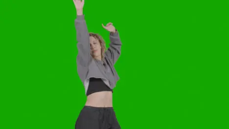 Studio Shot Of Young Woman Having Fun Dancing Against Green Screen 11