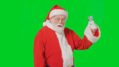 Portrait Shot of Santa Ringing a Bell In Front of Green Screen