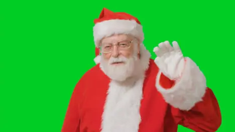 Portrait Shot of Santa Waving Hello to Camera with Green Screen