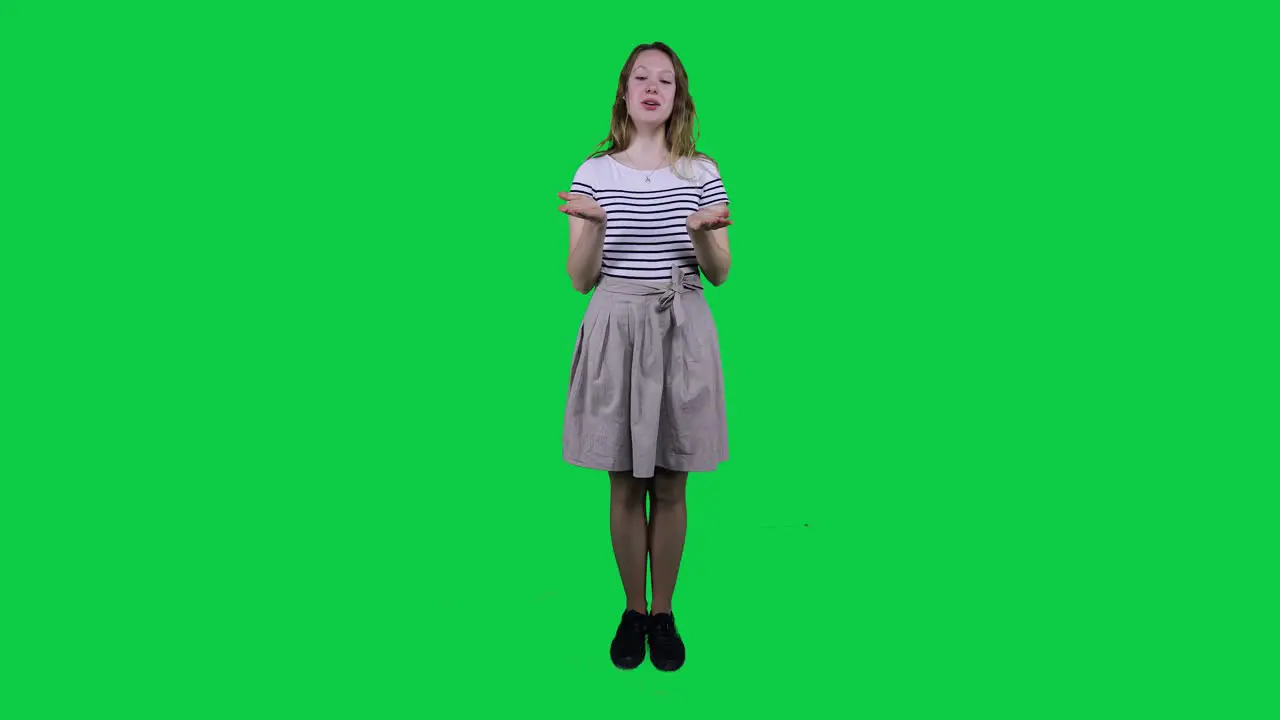 Teenage girl singing vibing to music in front of a green screen