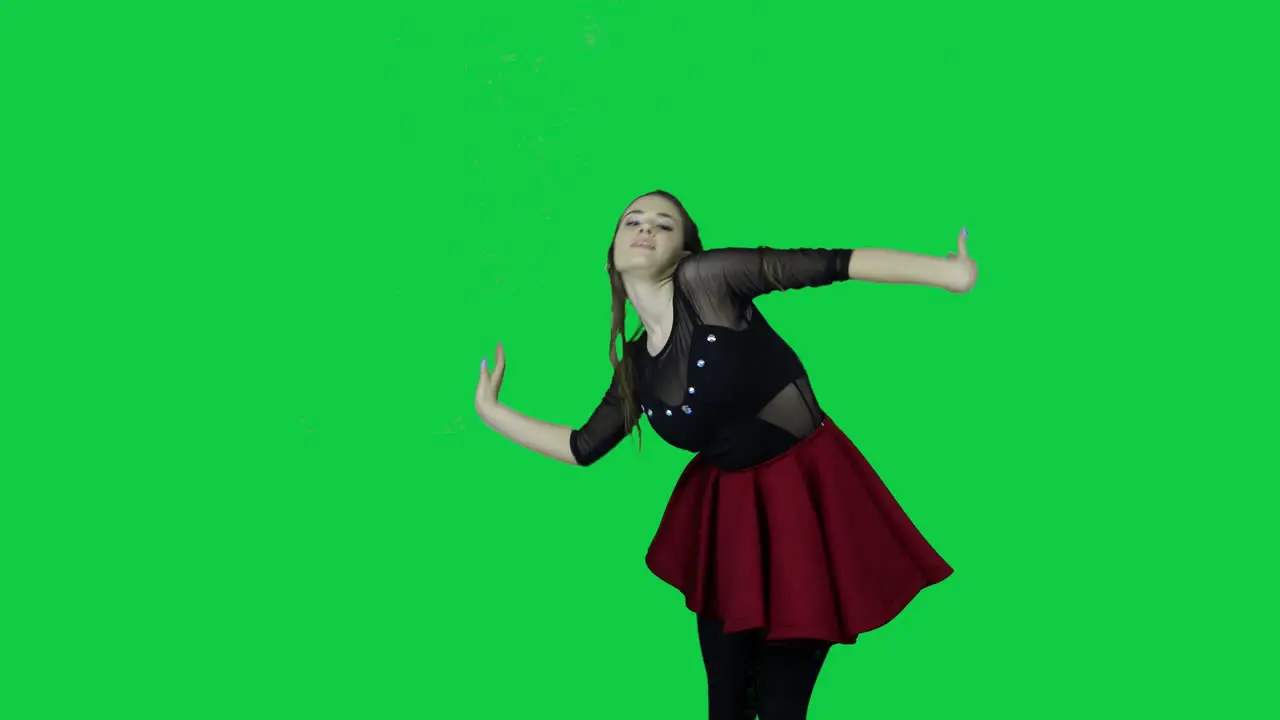 Close up to professional dancer slowly dancing in front of a green screen