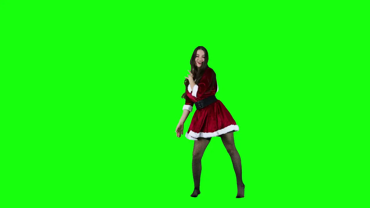 Attractive female dancer dancing in front of the green screen