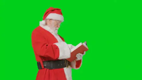 Portrait Shot of Santa Holding Reading Through Big Red Book