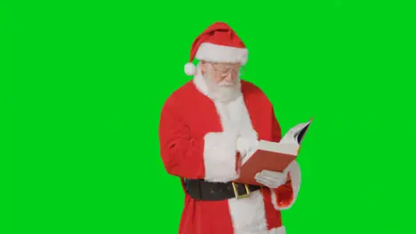 Portrait Shot of Santa Holding Reading Through a Big Red Book