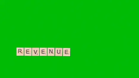 Stop Motion Business Concept Overhead Wooden Letter Tiles Forming Word Revenue On Green Screen 1