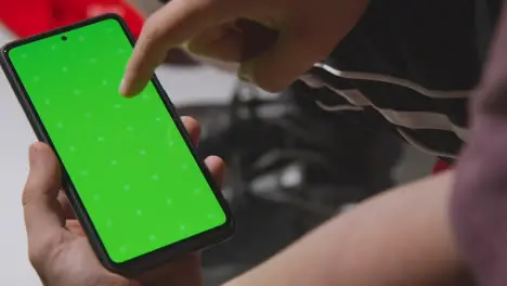 Close Up Of Man In Dressing Room Ready For Football Soccer Match Looking At Green Screen Mobile Phone