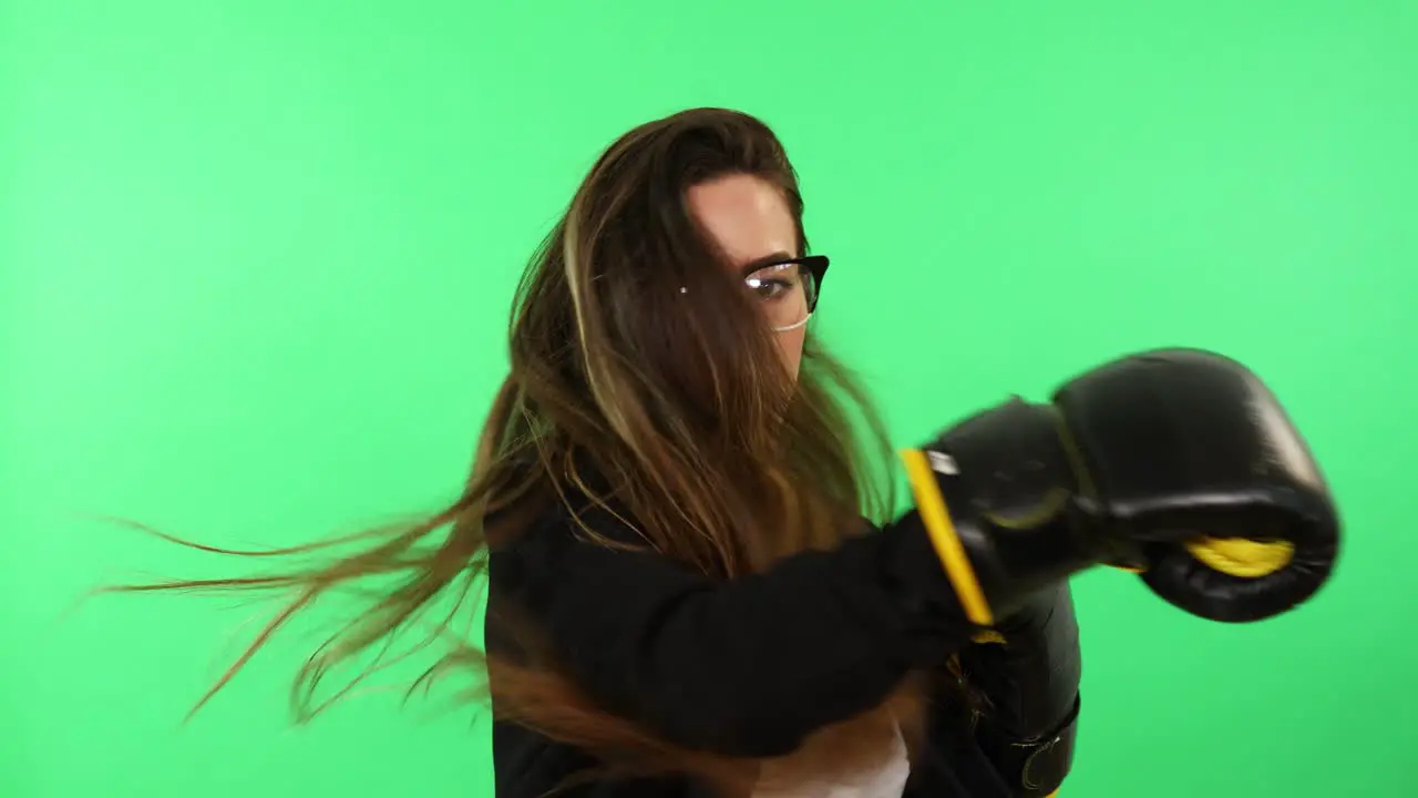 Businesswoman woman with glasses white shirt and black business suit wearing boxing gloves and punching stress