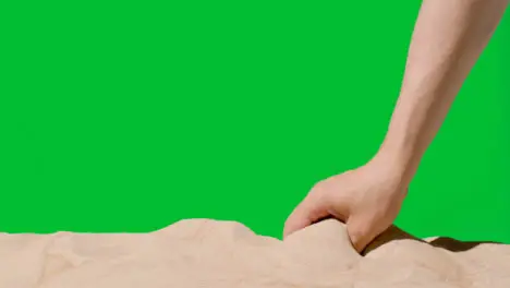 Summer Holiday Concept With Hand Picking Up Sand From Beach Against Green Screen 2