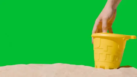 Summer Holiday Concept With Child's Bucket Spade On Sandy Beach Against Green Screen 3