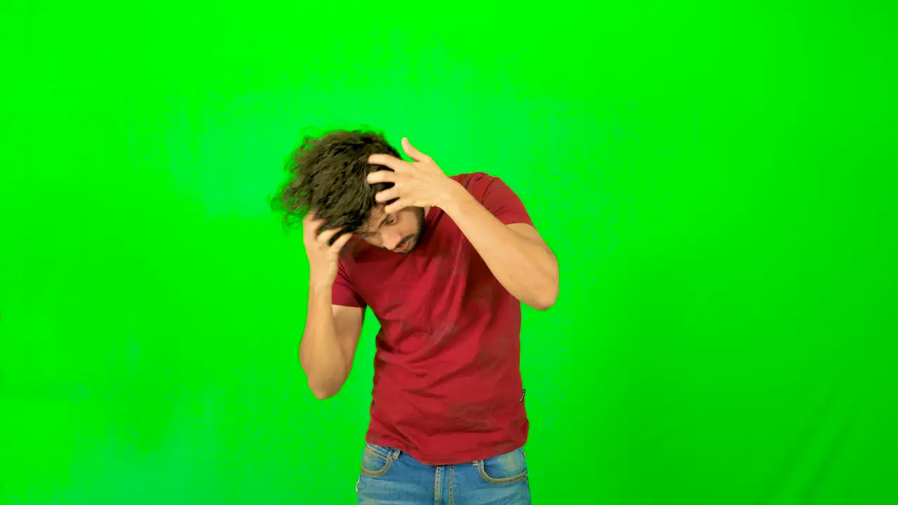 indian male model touching his hair with green screen green background