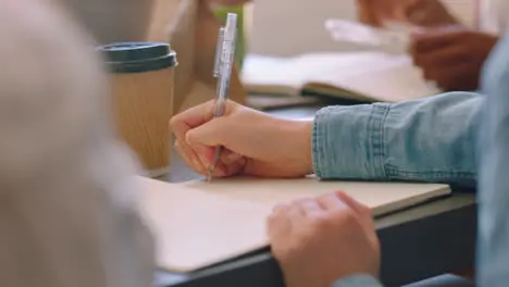 Business woman hands writing in business meeting