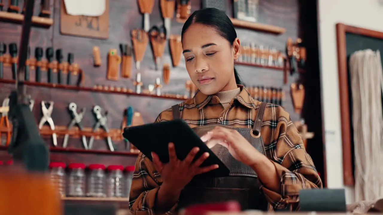 Leather workshop woman with tablet