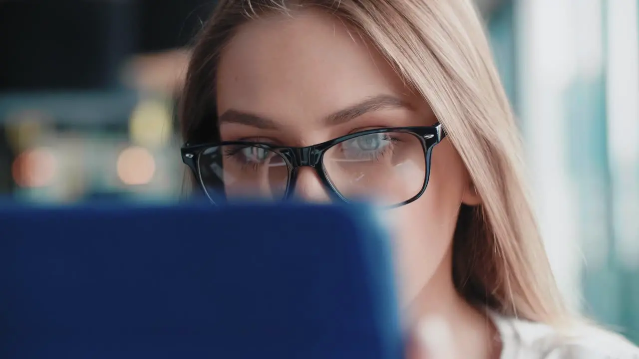 Close up of focused woman using tablet in the office