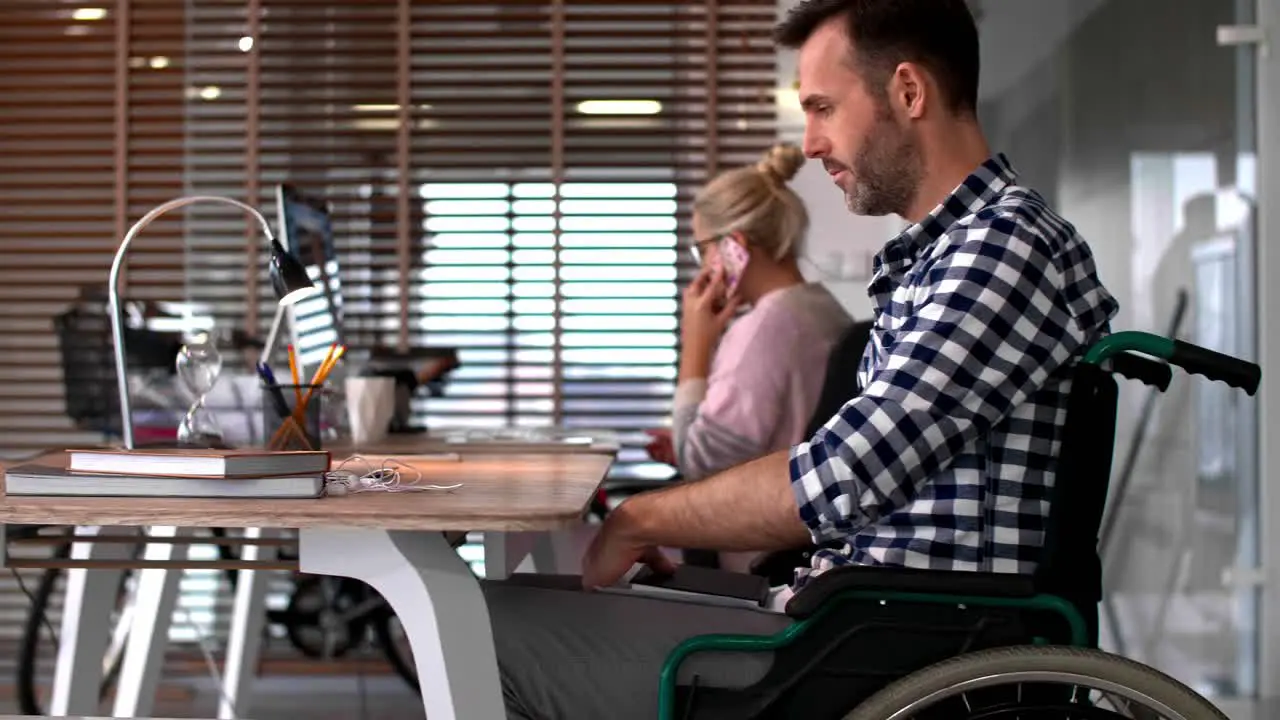 Close up of man's in a wheelchair in office