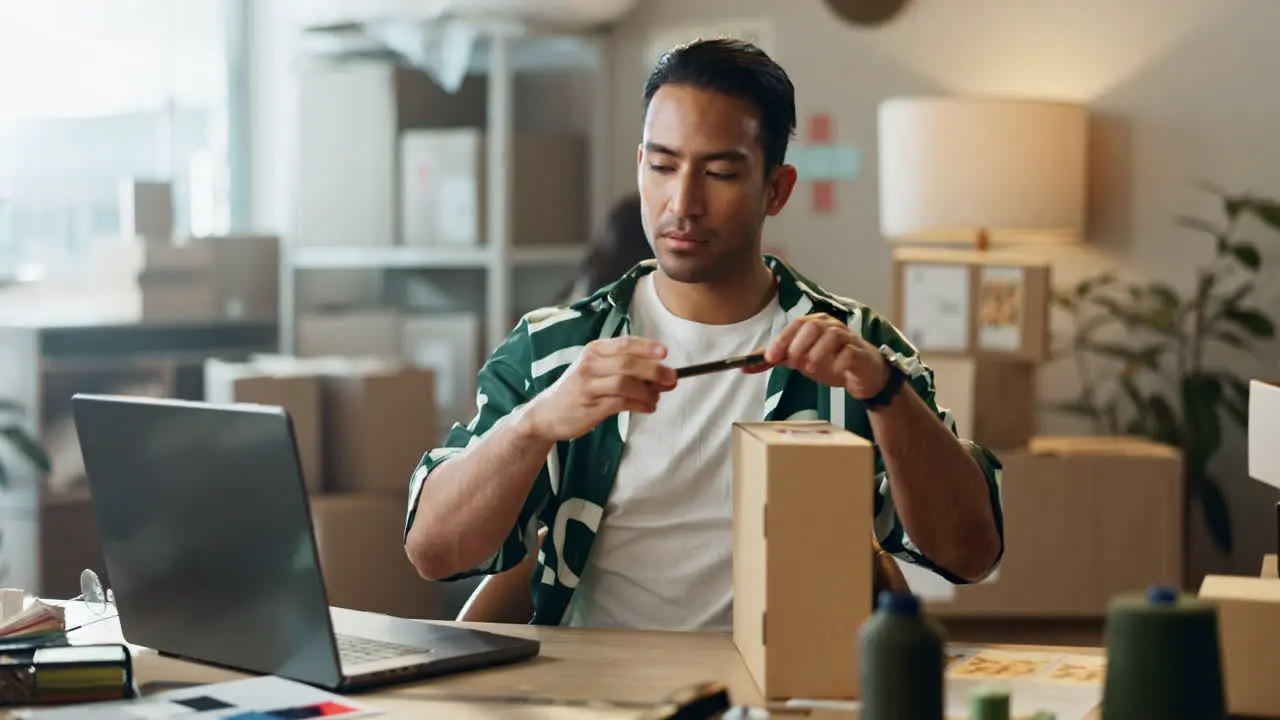 Ecommerce box and man with phone in office