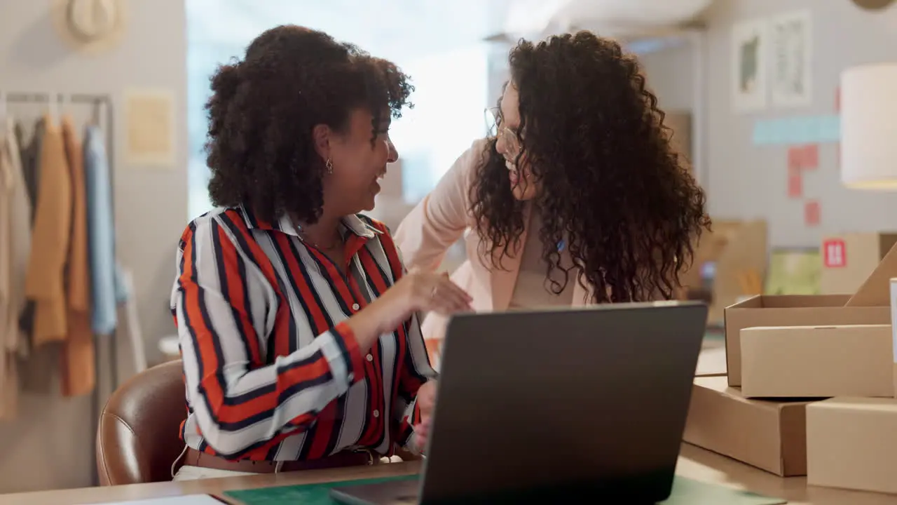 Designer women high five and laptop at workshop