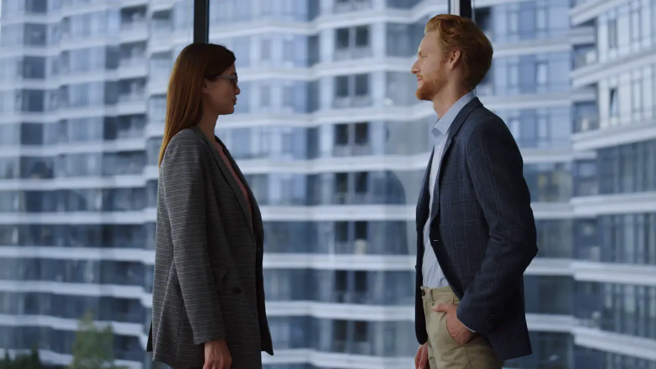 Businessman and businesswoman discussing plans Executives shaking hands