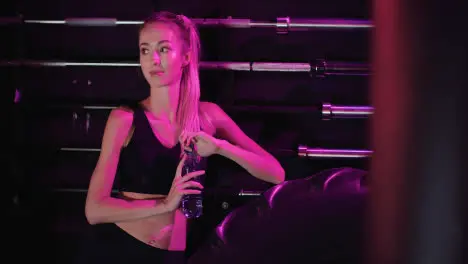 Smiling Confident Slim Female Athlete Drinking Water From Bottle At Fitness Club