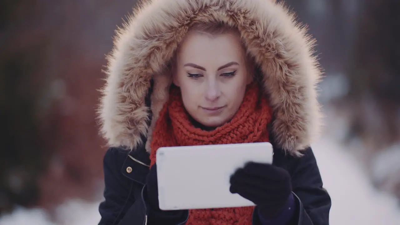 Female Tourist Using Digital Tablet In Forest In Winter 2