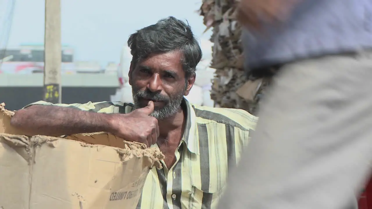 Man leaning on box at a recycling center