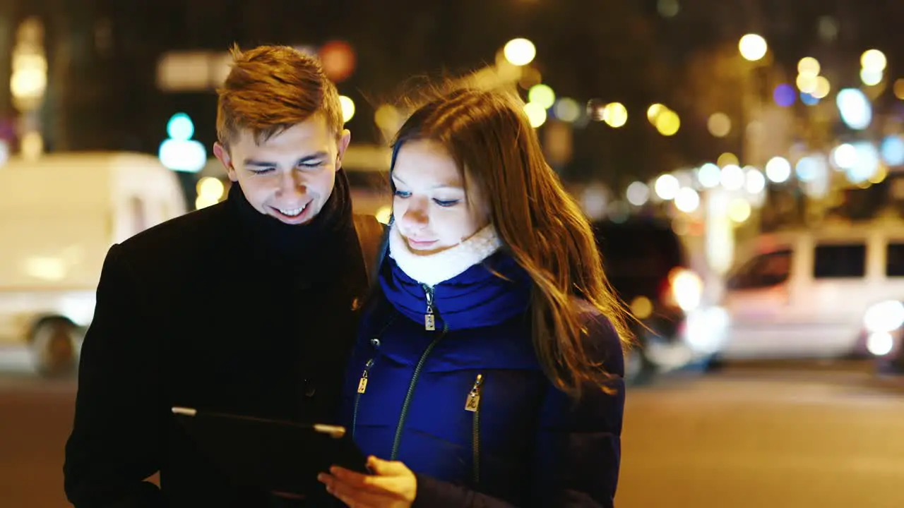 A young couple uses a tablet for directions 2