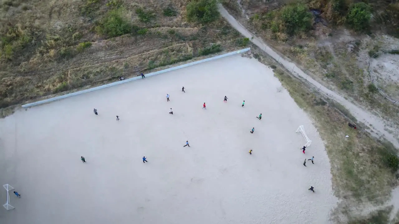 Group of kids playing soccer in Mexico in the evening