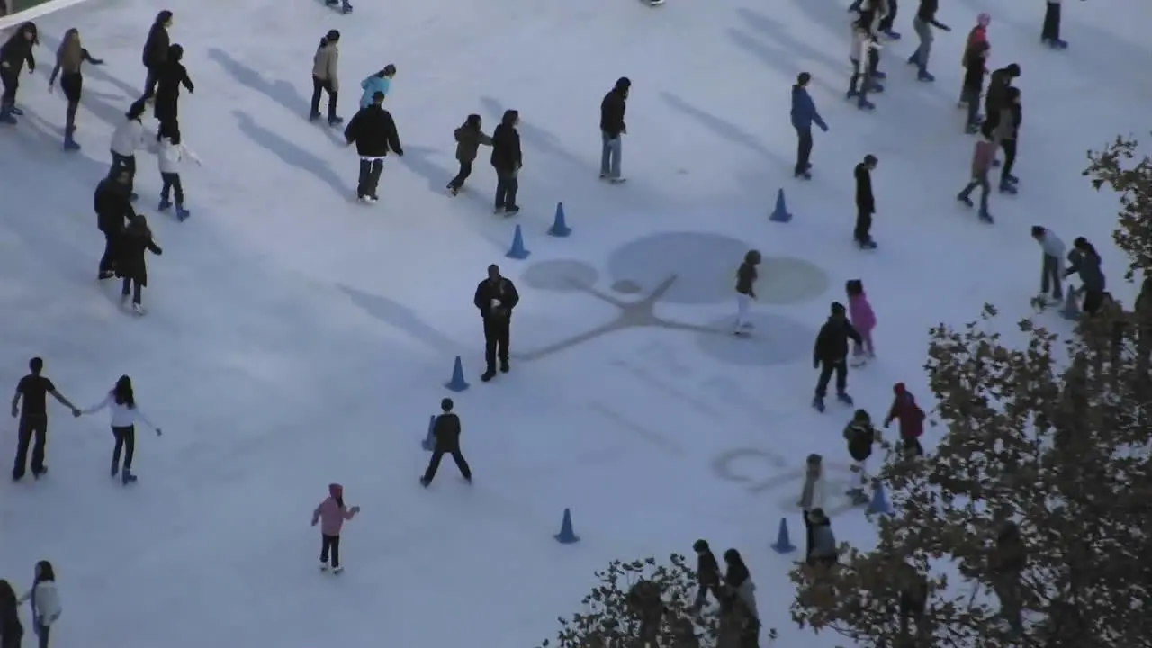 People are enjoying ice skating on a snowy floor