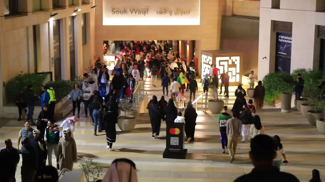 Souk Waqif in Qatar people are walking holding flags