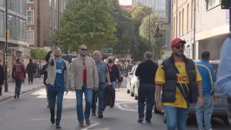 Fans Walking Through Streets Near he Emirates Stadium Home Ground Arsenal Football Club London With Supporters On Match Day