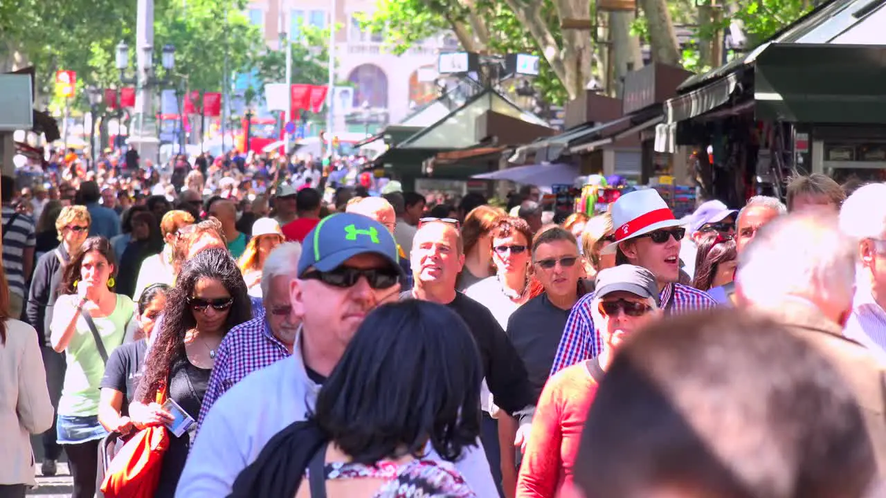 Crowds walk in a neighborhood in Barcelona Spain