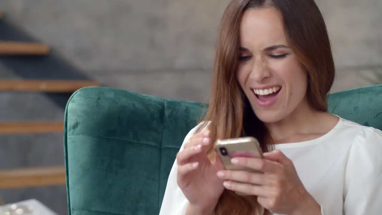 Business woman getting great news on smart phone in remote office