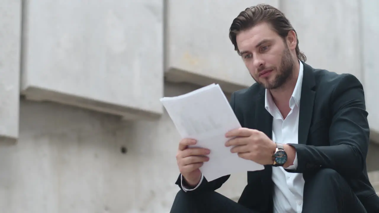 Man working with business papers on street Businessman examining statistics