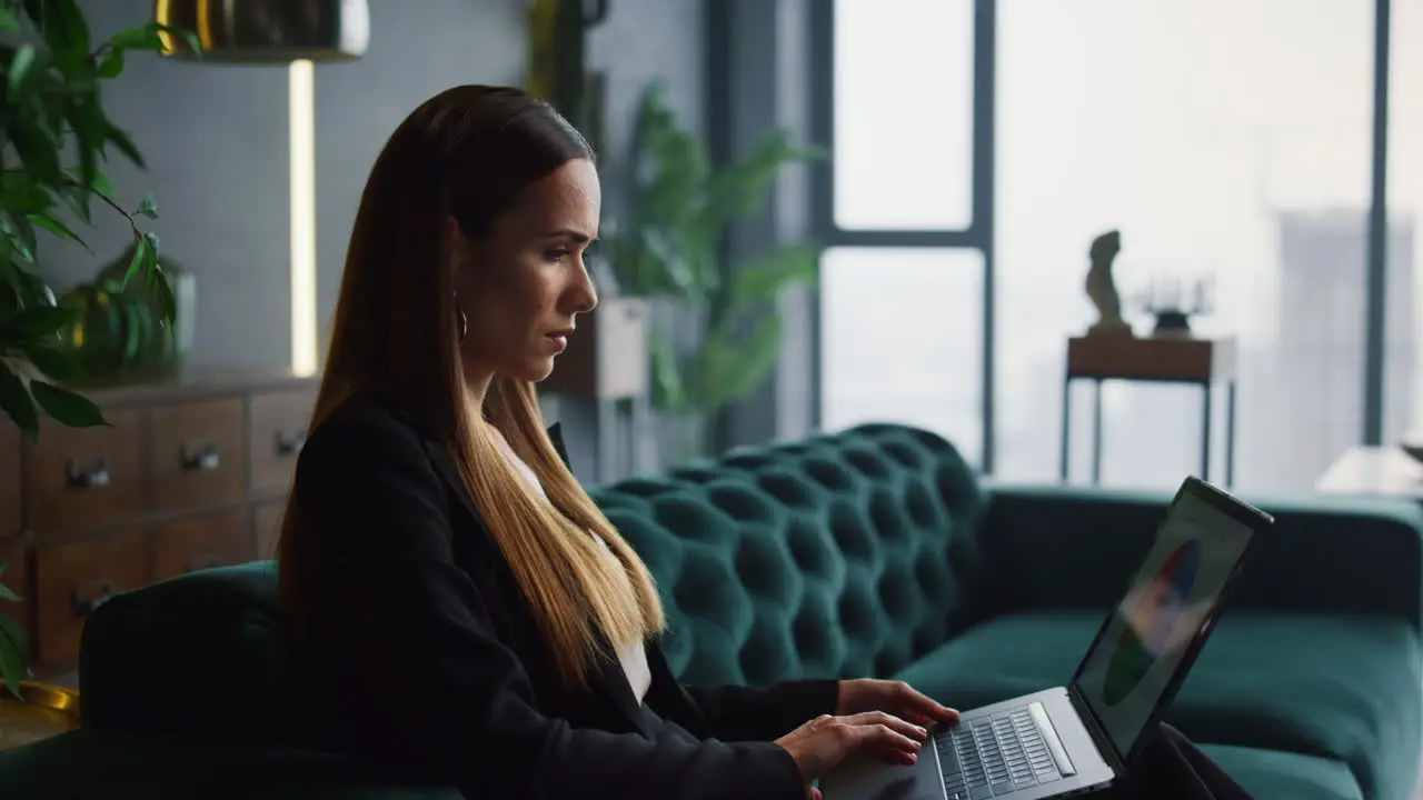 Businesswoman working on laptop at home office Businessman walking in office