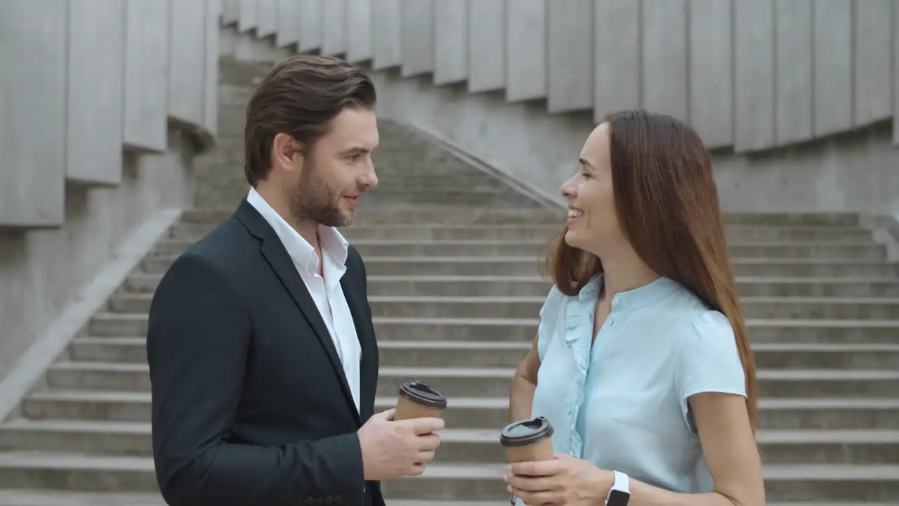 Cheerful coworkers talking in city Woman and man having meeting after work