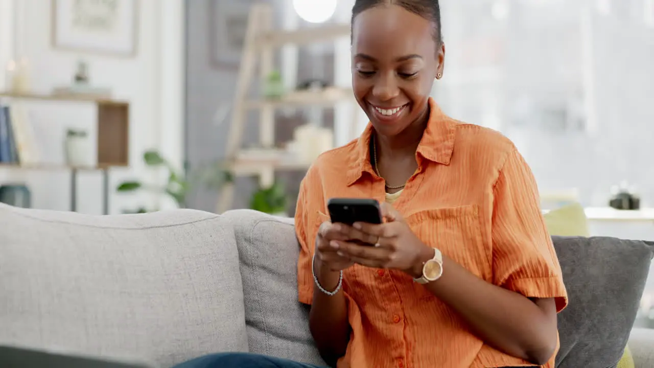 Black woman on couch smartphone