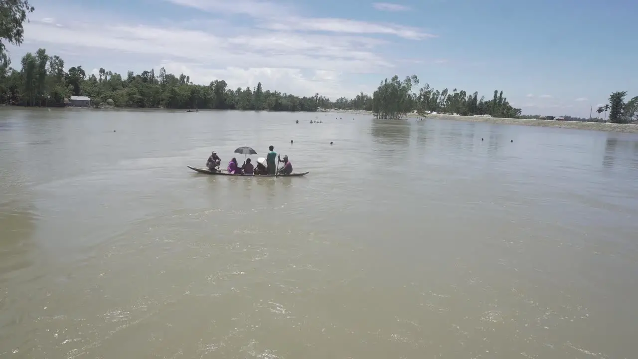 Flood-affected people of Bangladesh are moving in a boat after the flood has destroyed their houses