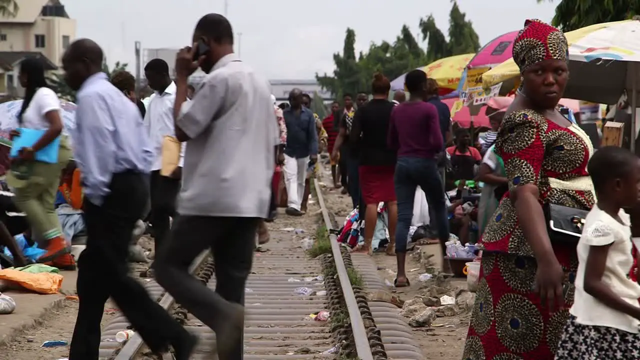 Crowded market people crossing raiway in Lagos Nigeria