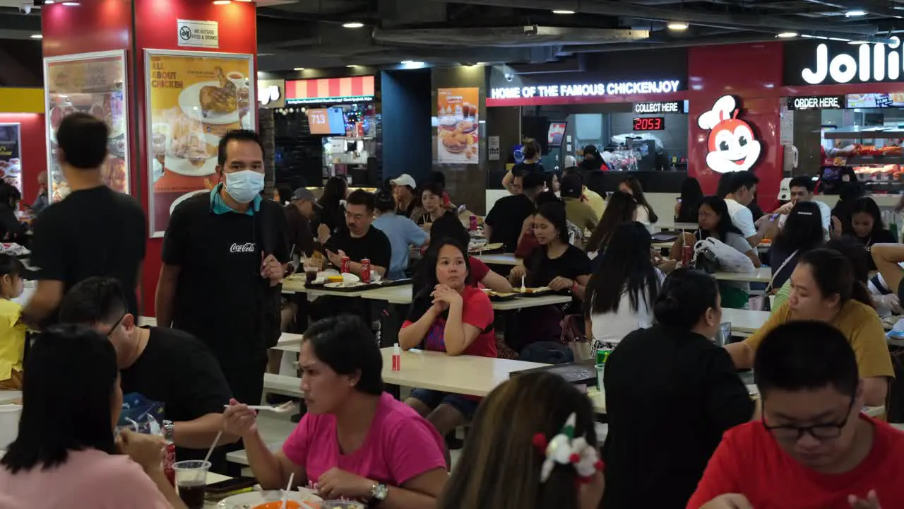 People eating at the food places inside the Mall of Lucky Plaza in Singapore