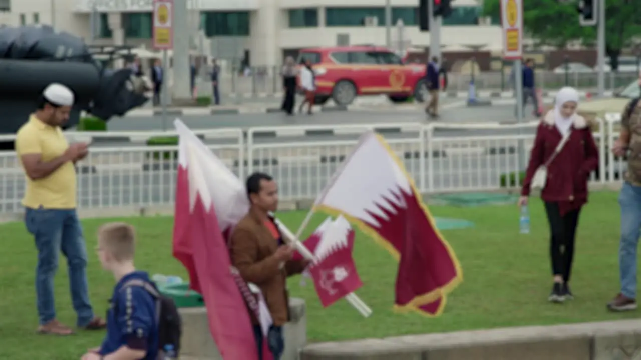 Man selling Qatari flags On National Day in Doha