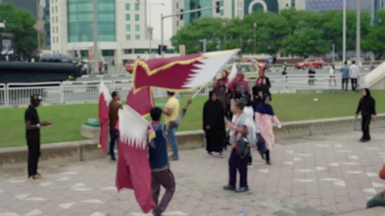 Man waiving Qatari flag on National Day