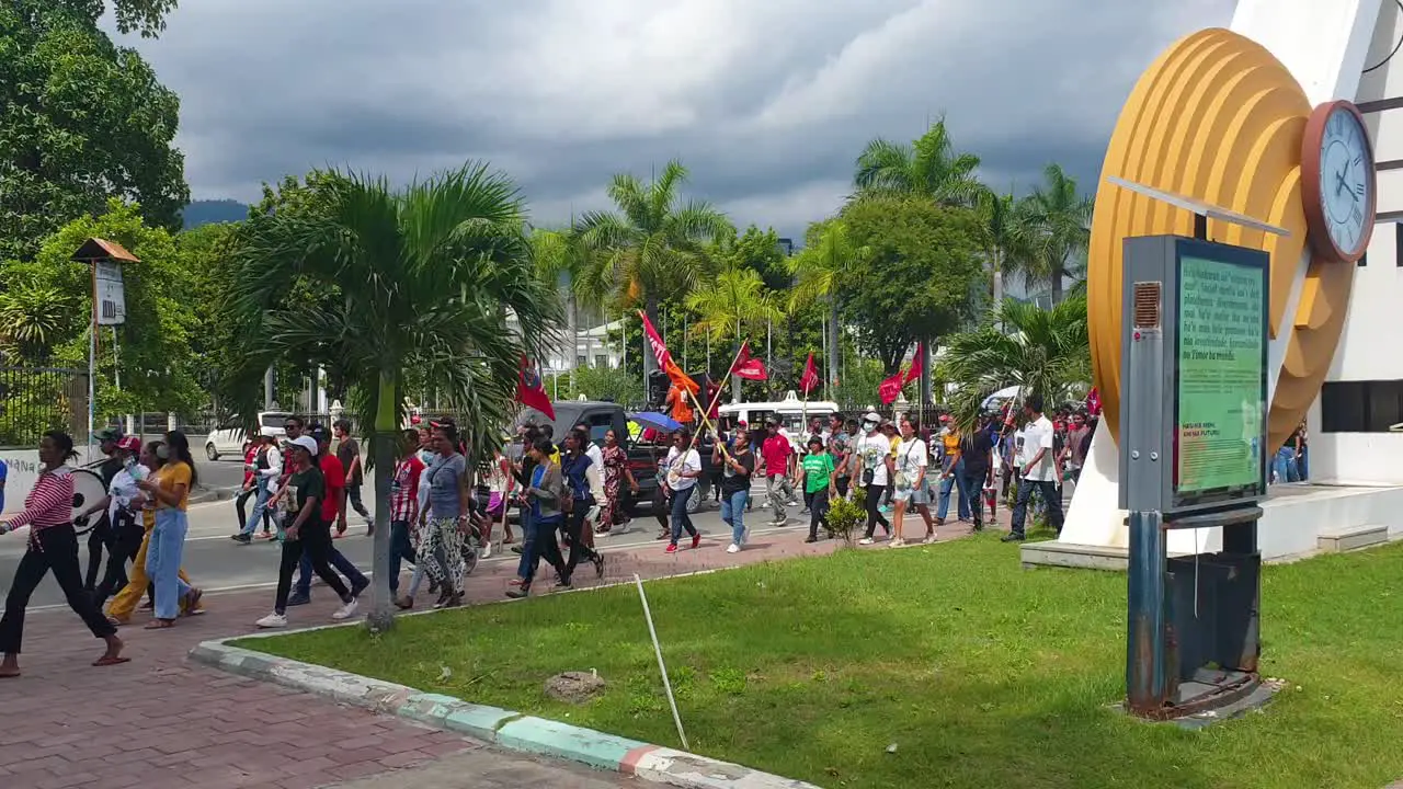 People marching with flags during political party campaign in the capital Dili Timor-Leste for upcoming election 2023