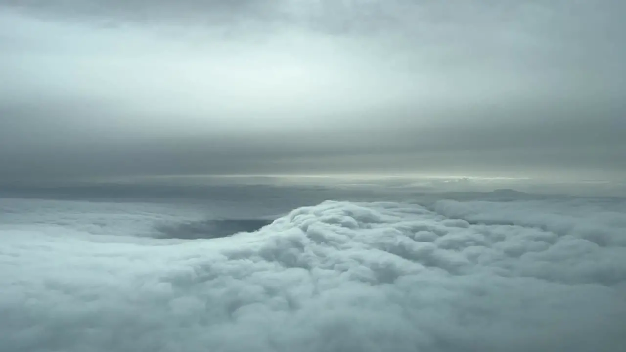 Aerial view from a cockpit flying trough nice winter snow clouds