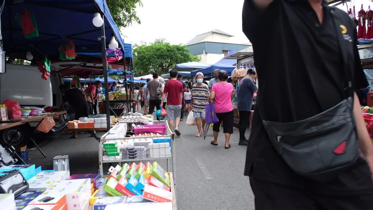 People walking around buying stuff along the street in Johor Bahru Malaysia