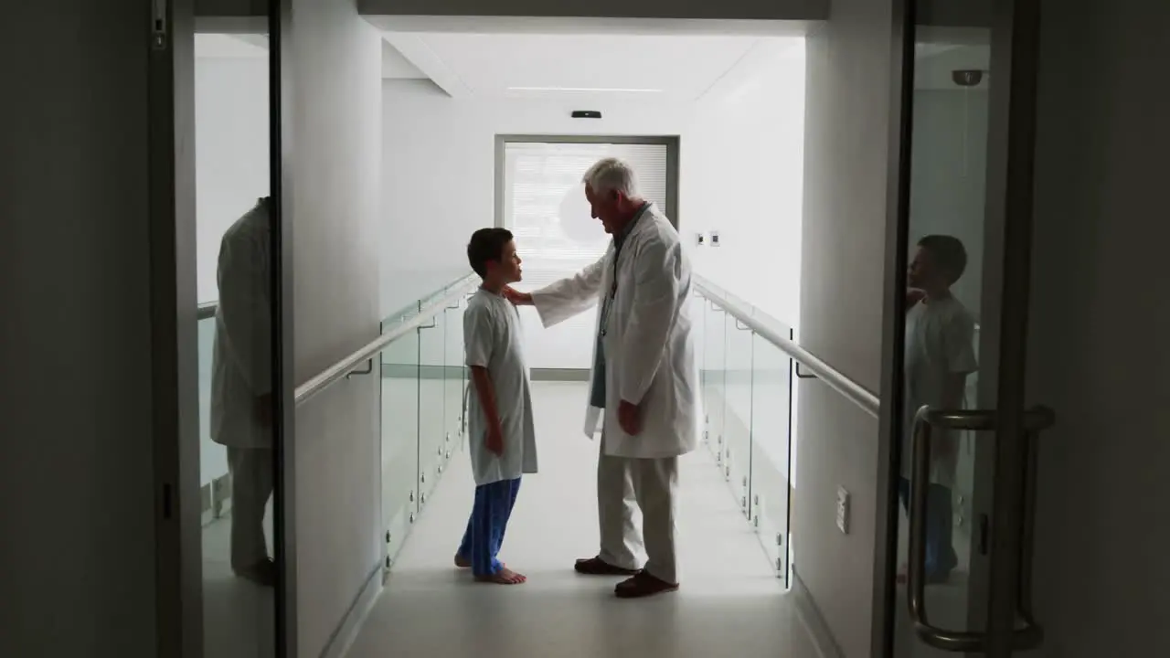 Doctor interacting with patient in corridor