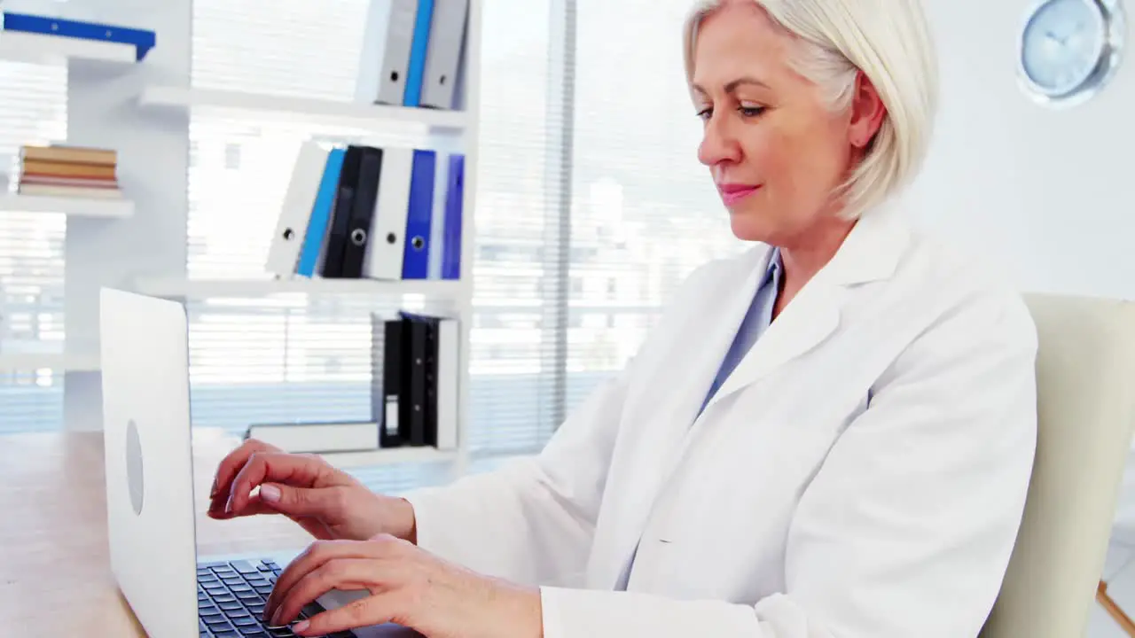 Female doctor working over laptop